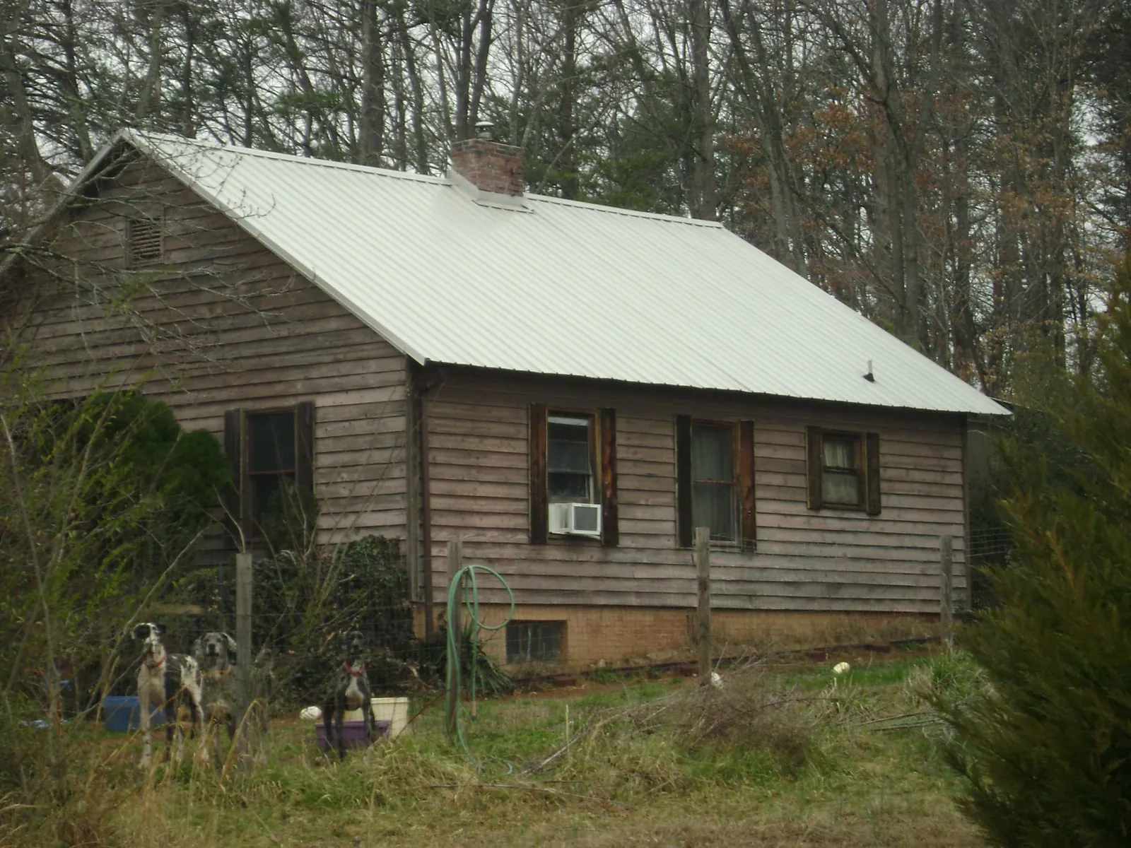 White metal roof on an old wood sided farmhouse, from a Metal Roof Installation job in Trumansburg